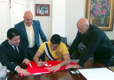 Signing the historical n3 shirt! (Photo courtesy: Government of Gibraltar)