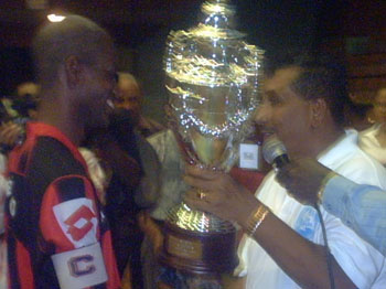 Zvv Mengao*s captain Gino Brandon receiving the champions trophy