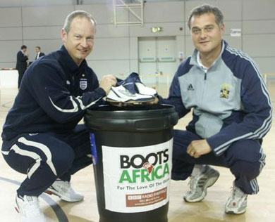 Graeme Dell hands over a pair of boots to Sheffield FC manager Dave McCarthy at the English Institute of Sport - Sheffield (Photo courtesy: HR Media)