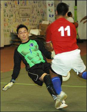 Guam Shipyard goalkeeper Lee Blevins slides and manages to deflect a shot by Eric Sotto of the Dodge Rams in the 2006 Gatorade/GFA Men*s Futsal League championship last night (Photo courtesy: GUAM PDN.com)